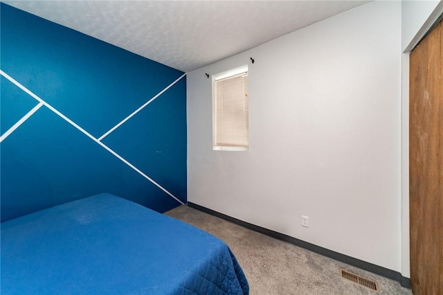 unfurnished bedroom with carpet floors, a textured ceiling, and a closet