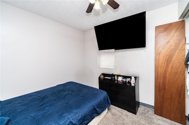 bedroom featuring light colored carpet and ceiling fan