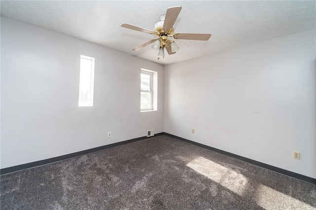 carpeted spare room with a textured ceiling and ceiling fan