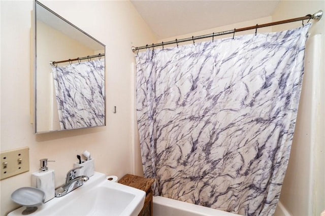 bathroom featuring sink and shower / bath combo with shower curtain