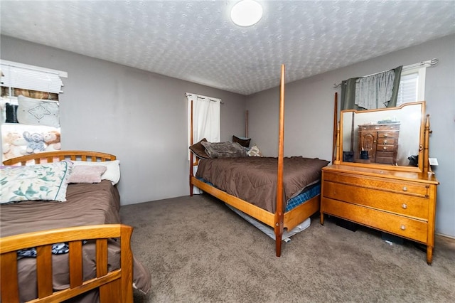 carpeted bedroom featuring a textured ceiling