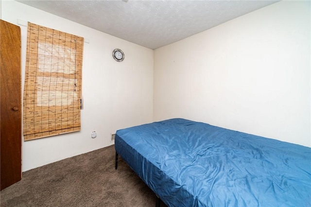 carpeted bedroom with a textured ceiling