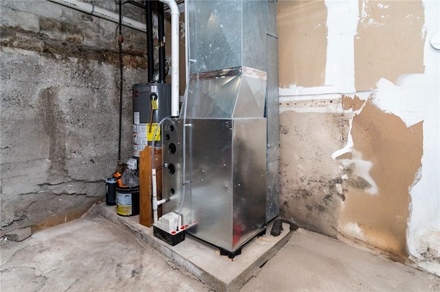 utility room with heating unit and gas water heater