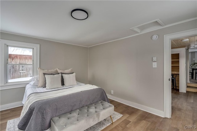 bedroom with hardwood / wood-style flooring and crown molding