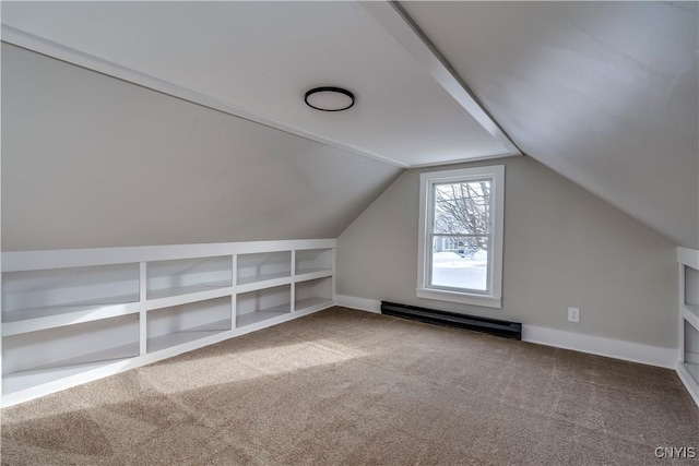 bonus room featuring built in shelves, vaulted ceiling, carpet, and a baseboard heating unit