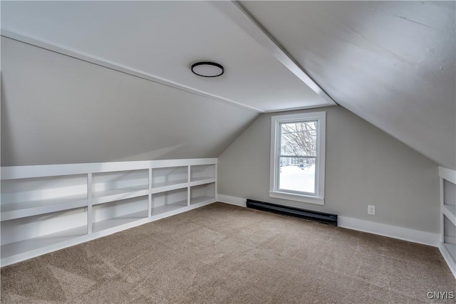 bonus room featuring baseboard heating, light colored carpet, vaulted ceiling, and built in features