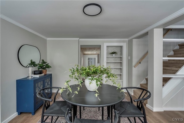 dining room with wood-type flooring and ornamental molding