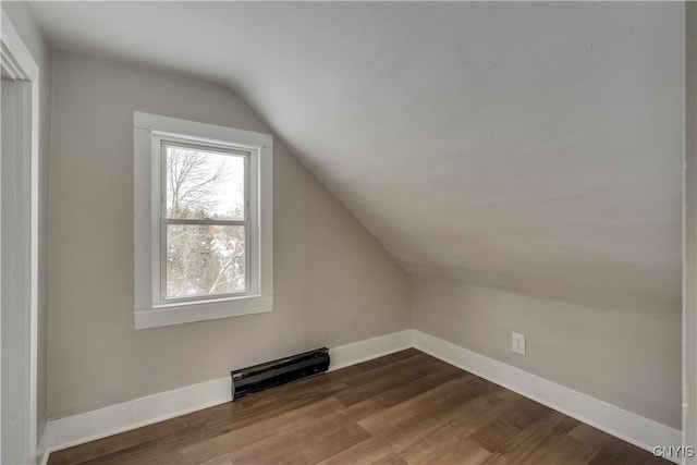 bonus room with dark hardwood / wood-style flooring and vaulted ceiling