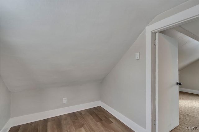 additional living space with lofted ceiling and hardwood / wood-style floors