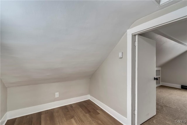 additional living space featuring vaulted ceiling and hardwood / wood-style floors