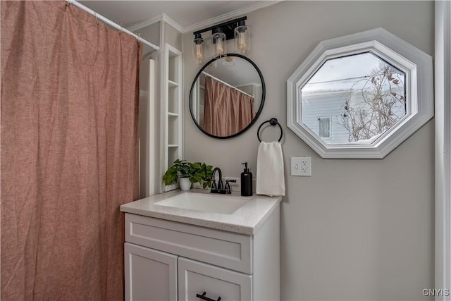 bathroom with vanity and ornamental molding