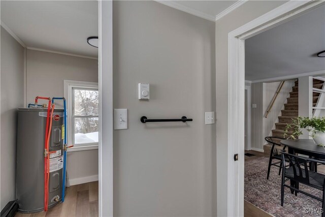 bathroom featuring crown molding, electric water heater, and hardwood / wood-style flooring