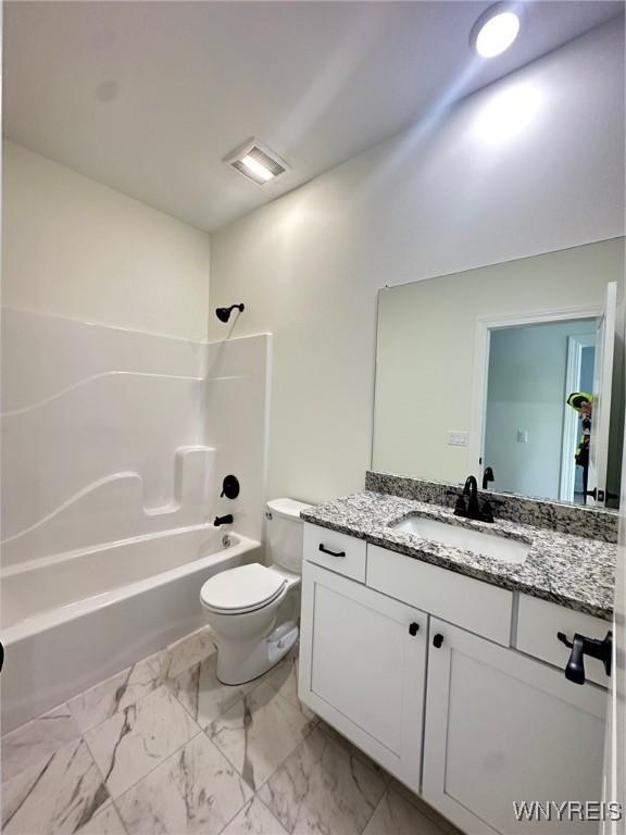 full bathroom with vanity, washtub / shower combination, and toilet