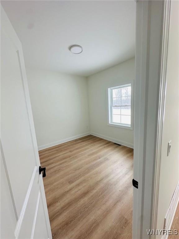 unfurnished room with light hardwood / wood-style flooring