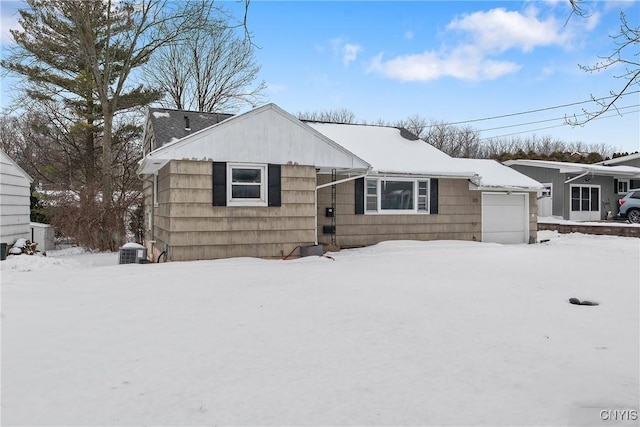 single story home featuring a garage and central air condition unit