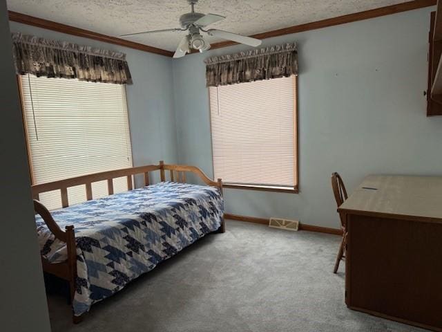 bedroom with ornamental molding, carpet flooring, and a textured ceiling