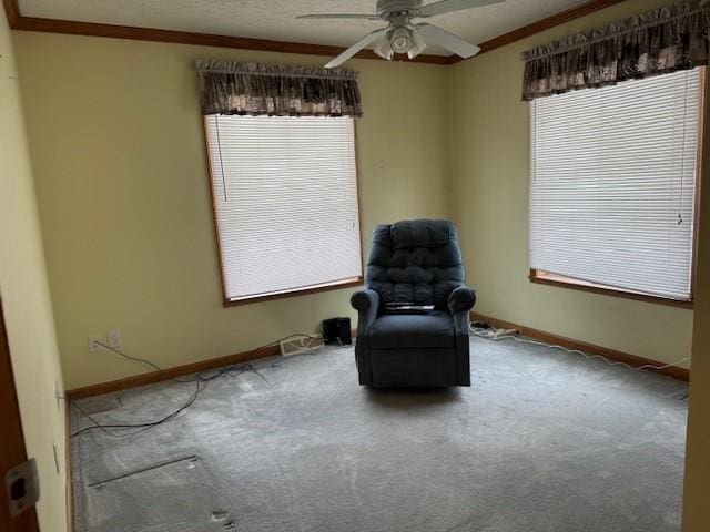 unfurnished room with ornamental molding, carpet, a wealth of natural light, and ceiling fan