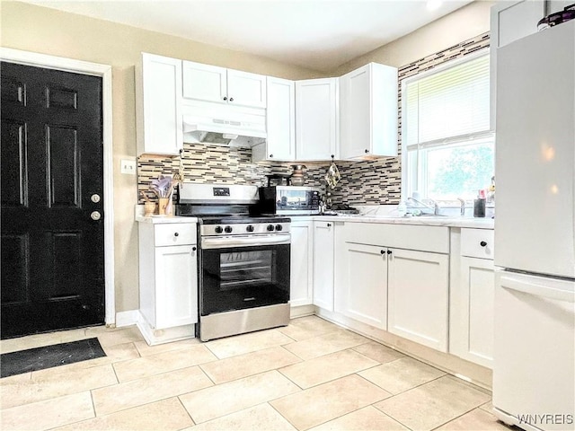 kitchen with decorative backsplash, exhaust hood, white cabinets, and appliances with stainless steel finishes