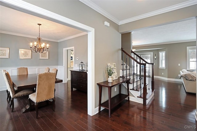 dining room with crown molding, dark hardwood / wood-style floors, and a chandelier