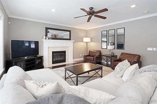 living room featuring crown molding, ceiling fan, and hardwood / wood-style flooring