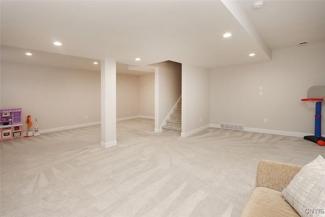 basement featuring light carpet