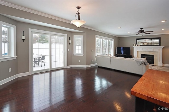 unfurnished living room with ceiling fan, ornamental molding, dark hardwood / wood-style floors, and a high end fireplace