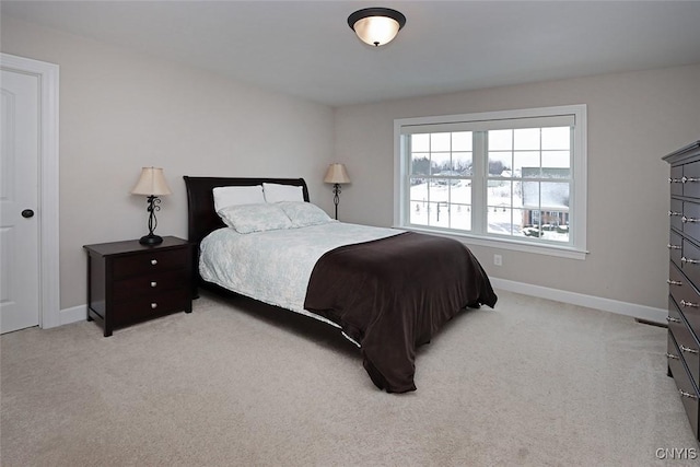 bedroom featuring light carpet