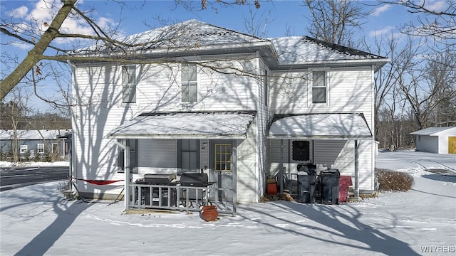 snow covered house with a porch