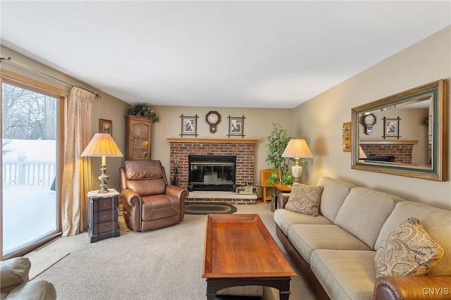 living room with a brick fireplace and carpet floors