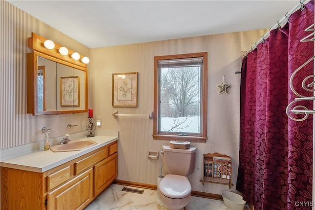 bathroom featuring vanity, toilet, and a shower with shower curtain