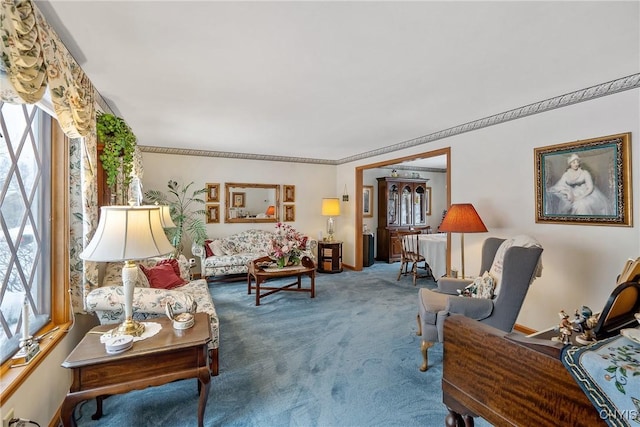 carpeted living room with ornamental molding