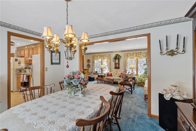 carpeted dining room with an inviting chandelier