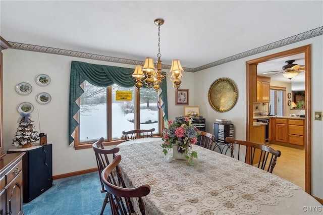 carpeted dining room with ceiling fan with notable chandelier