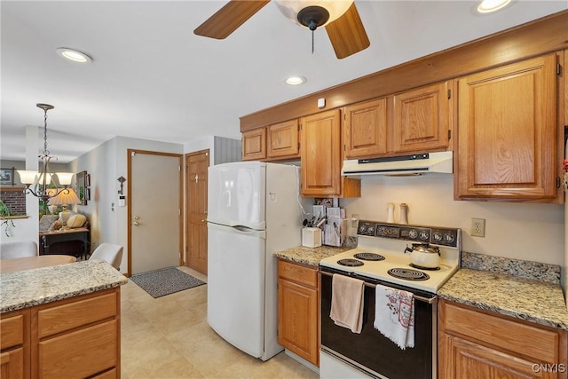 kitchen with ceiling fan with notable chandelier, light stone countertops, pendant lighting, and white appliances