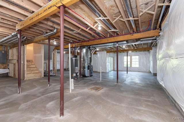 basement with electric panel, heating unit, and gas water heater