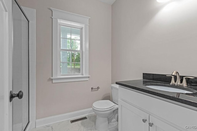 bathroom featuring vanity, toilet, and an enclosed shower