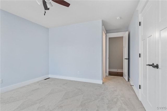 unfurnished room with light carpet and ceiling fan