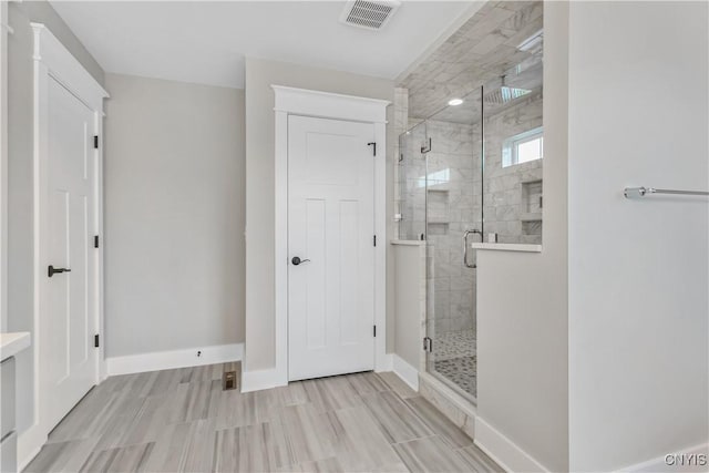 bathroom with a shower with door