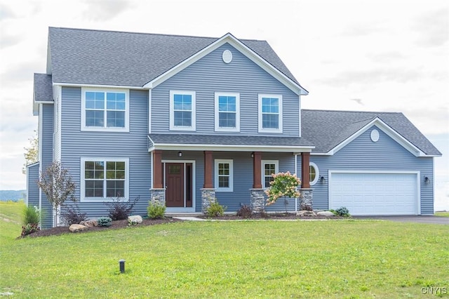 view of front of property featuring a garage, a porch, and a front yard