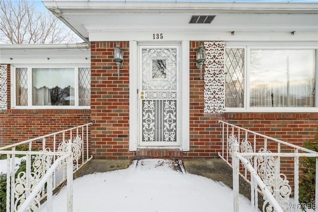 view of snow covered property entrance