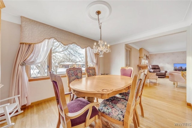 dining area with a notable chandelier and light wood-type flooring