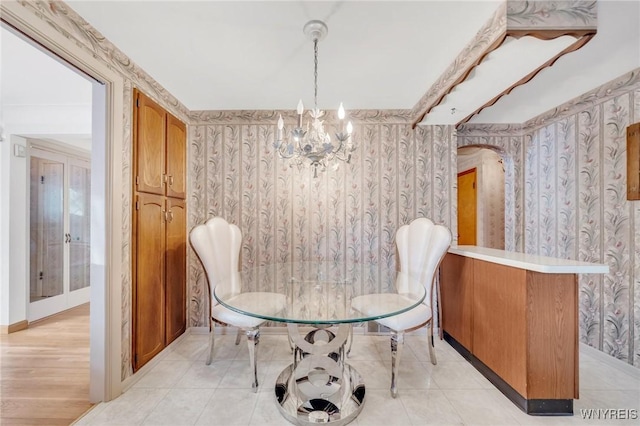 tiled dining space with an inviting chandelier