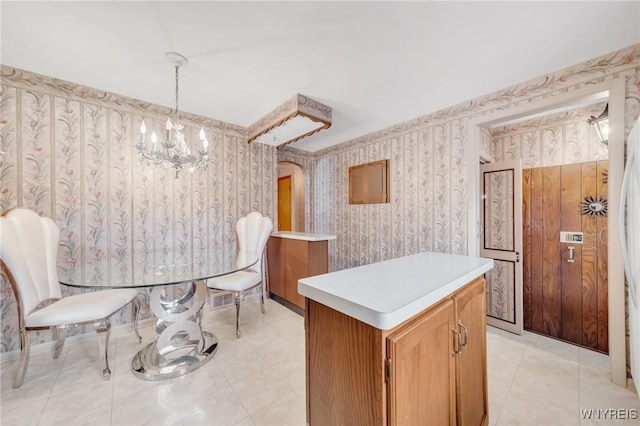 tiled dining room with a chandelier