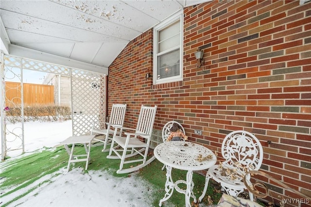 snow covered patio featuring covered porch