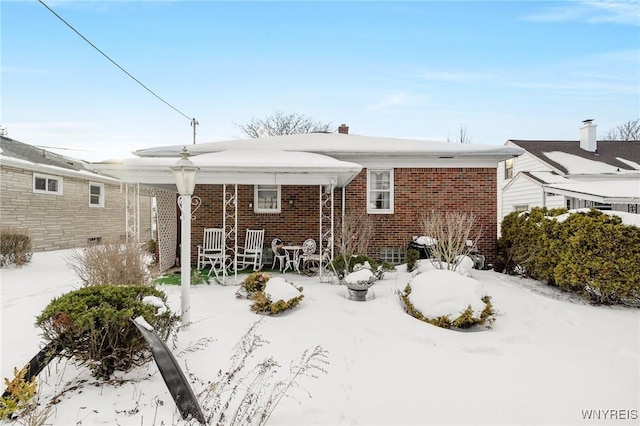 view of snow covered house