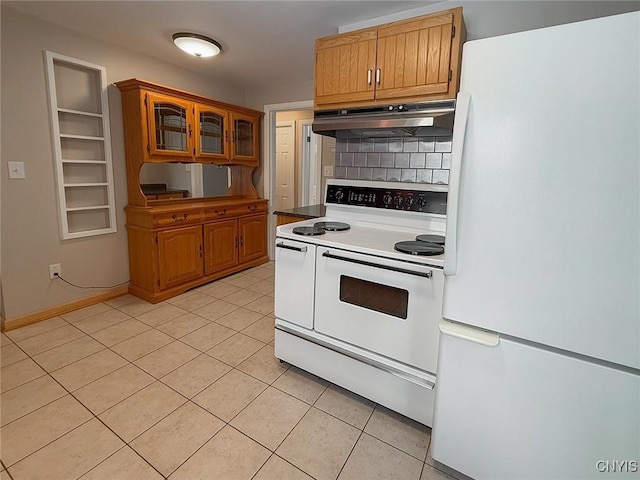 kitchen featuring white appliances, decorative backsplash, and light tile patterned floors