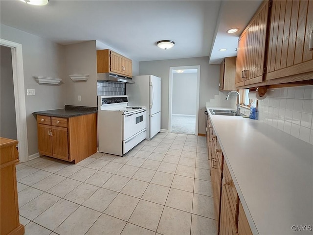 kitchen featuring sink, white appliances, decorative backsplash, and light tile patterned floors