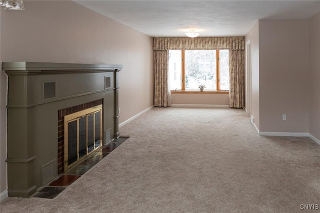 unfurnished living room with a tile fireplace and carpet