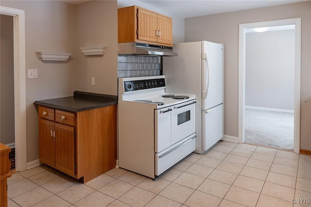 kitchen featuring white appliances and light tile patterned flooring