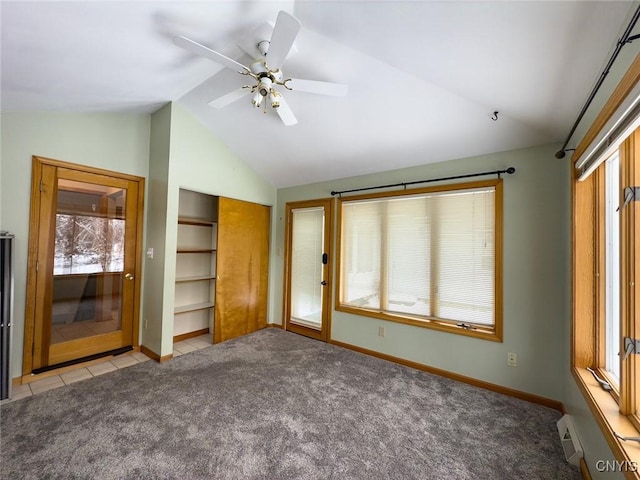 unfurnished bedroom with ceiling fan, light colored carpet, lofted ceiling, and a closet